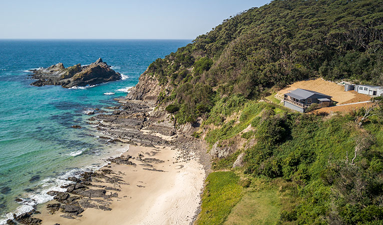 Aerial view of Davies Cottage, set on a hill above Boat Beach and Sugarloaf Bay in Myall Lakes National Park. Photo: John Spencer &copy; DPIE