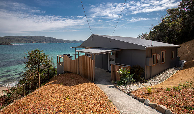 Pathway leading to Davies Cottage with Sugarloaf Bay in the background. Photo: John Spencer &copy; DPIE