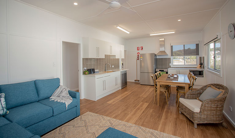 The lounge, dining room and kitchen in Davies Cottage, Myall Lakes National Park. Photo: John Spencer &copy; DPIE