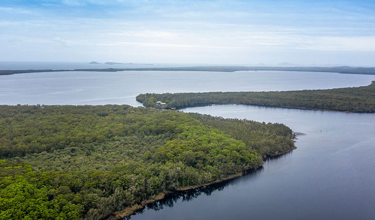 Aerial view of bush and water surrounding Joes Cove campground in Myall Lakes National Park. Photo: John Spencer &copy; DPIE