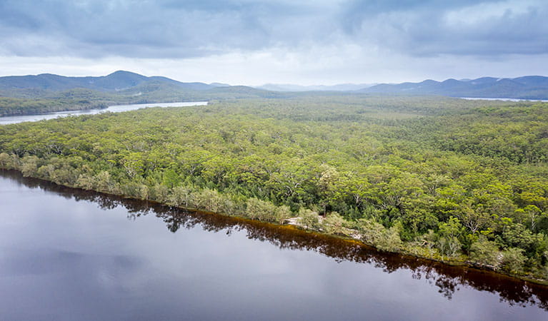 Aerial view of remote Two Mile Sands campground with surrounding bushland and waterways in Myall Lakes National Park. Photo: John Spencer &copy; DPIE