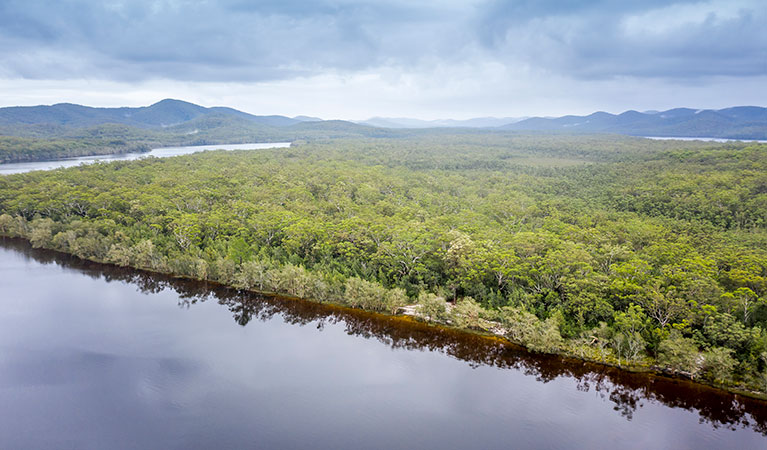 Aerial view of remote Two Mile Sands campground with surrounding bushland and waterways in Myall Lakes National Park. Photo: John Spencer &copy; DPIE