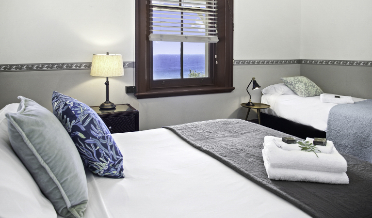 Second bedroom in Head Keeper's cottage with 1 queen and 1 single bed. Photo: Seal Rocks Lighthouse Cottages