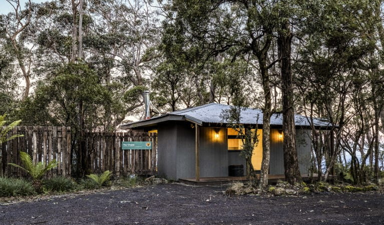 The front exterior of The Chalet surrounded by trees in New England National Park. Photo: Mitchell Franzi &copy; DPIE