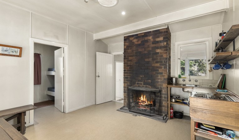 The interior of Toms Cabin with fireplace in New England National Park. Photo:  Mitchell Franzi &copy; DPIE