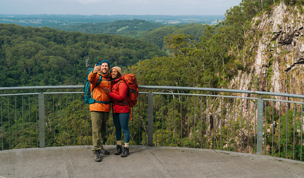 Walkers taking a photo at Minyon Falls lookout. Credit: Remy Brand/DCCEEW © Remy Brand
