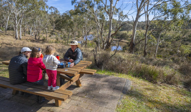 Family sitting at picnic table at Apsley Falls picnic area Oxley Wild Rivers National Park. Photo: John Smith &copy; DPIE