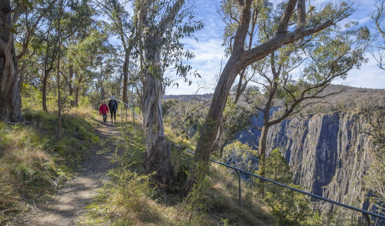 Two people walking near Apsley Falls in Oxley Wild Rivers National Park. Photo: John Smith &copy; DPIE