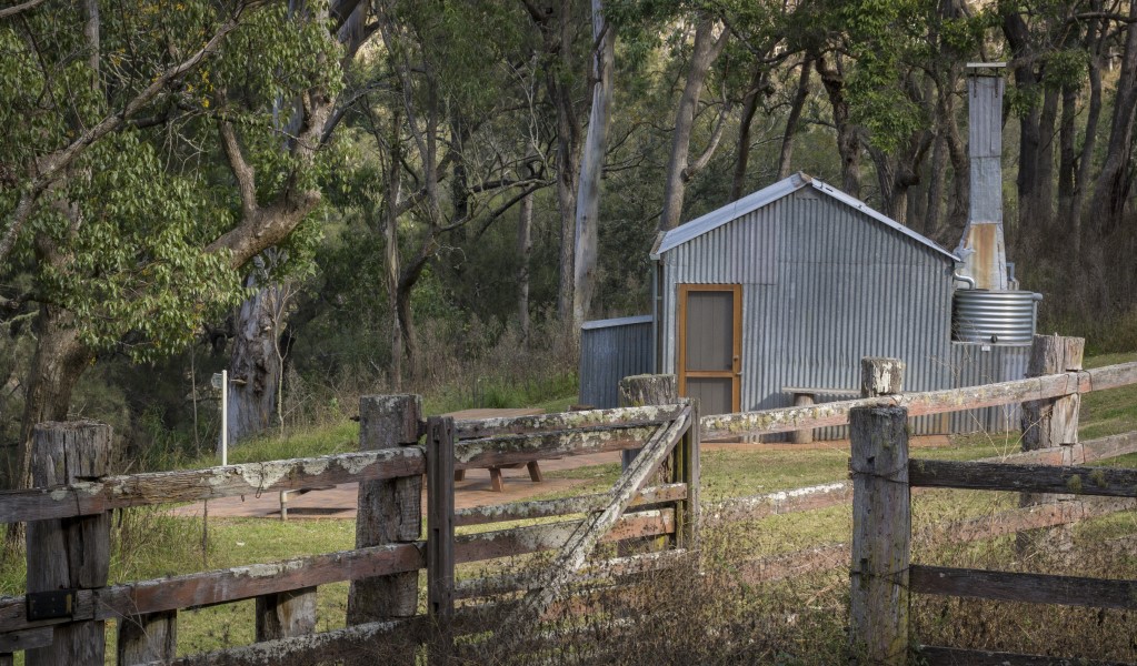 A hut behind a fence along Green Gully track. Photo: Gerhard Koertner &copy; DPE