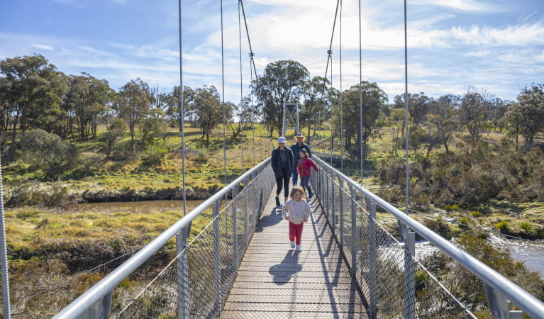 Adults and children walking on suspension bridge Oxley Wild Rivers National Park. Photo: John Smith &copy; DPIE