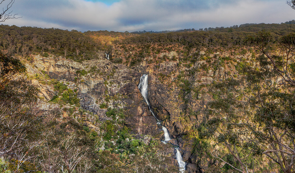 View of waterfall cascading off a ridge in a wilderness setting. Photo &copy; Gerhard Koertner