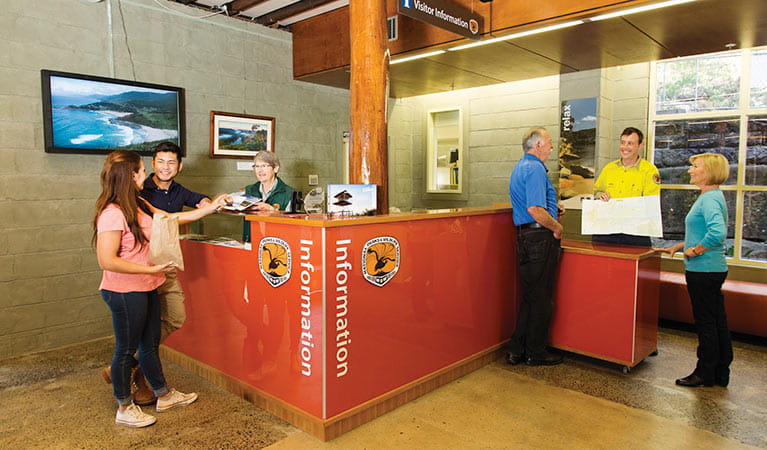 NPWS staff and visitors at the information desk in Royal National Park Visitor Centre, Royal National Park. Photo: Simone Cottrell &copy; DPIE