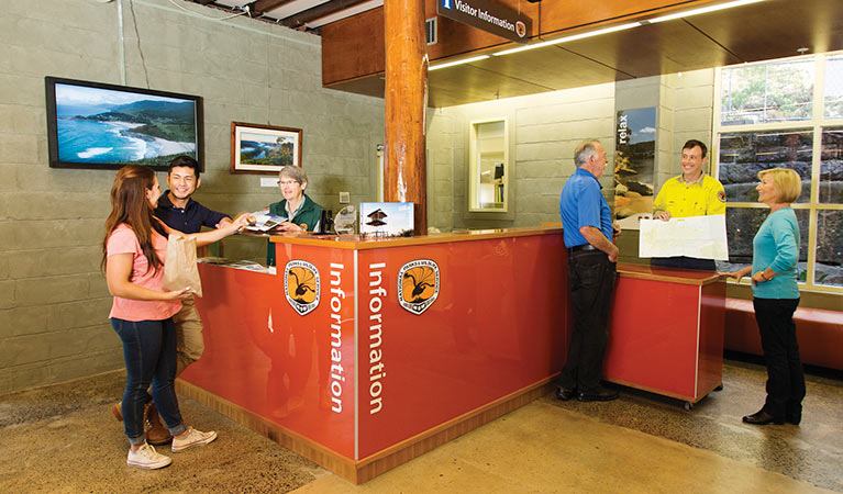 NPWS staff and visitors at the information desk in Royal National Park Visitor Centre, Royal National Park. Photo: Simone Cottrell &copy; DPIE