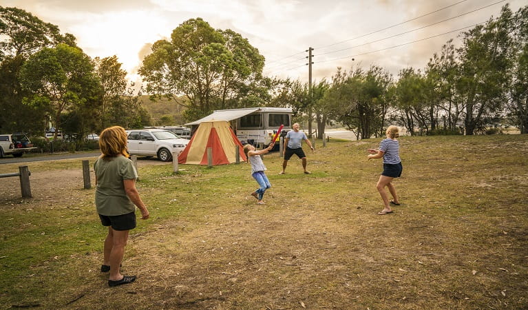 Visitors enjoying a casual game of cricket outside their campervan at Bonnie Vale. Photo: John Spencer, OEH