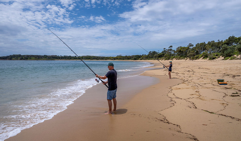 2 people beach fishing near Bonnie Vale campground in Royal National Park. Credit: John Spencer © DCCEEW