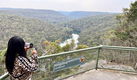 Woman takes photo of views from Bungoona lookout. Credit: Natasha Webb &copy; DCCEEW