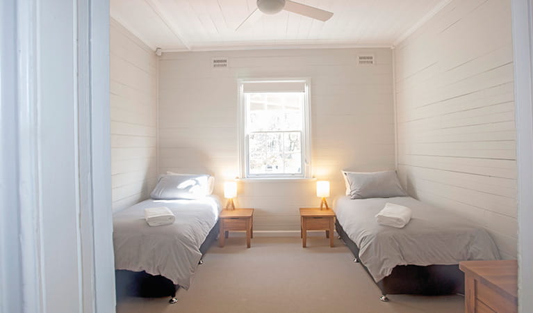 A bedroom with 2 single beds in Reids Flat Cottage, Royal National Park. Photo: Rosie Nicolai/DPIE
