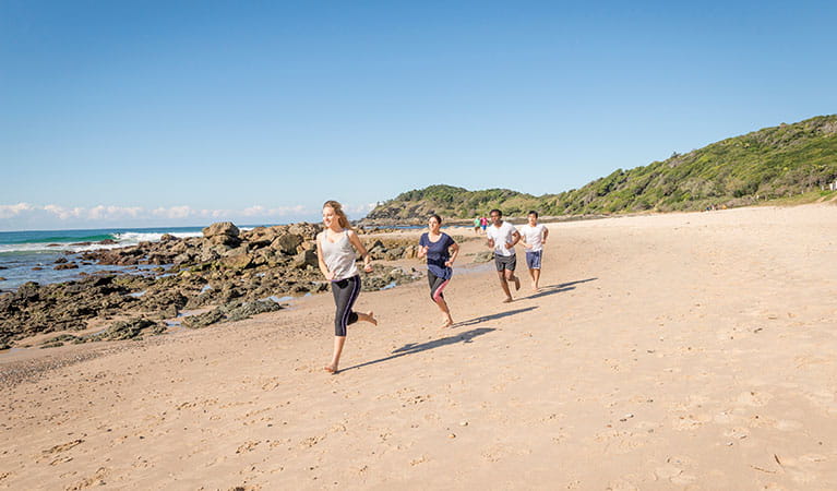 A group of people exercising on the beach along the Port Macquarie coastal walk in Sea Acres National Park. Photo: John Spencer &copy; DPIE