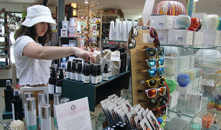 Girl shopping for natural skin products at Sea Acres Rainforest Centre. Photo: Natasha Webb &copy; DPIE