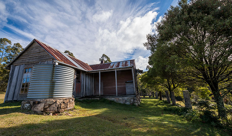 Close up of Alexanders Hut with water tank in the foreground. Photo: John Spencer/OEH