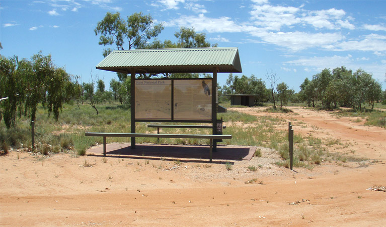 Picnic tables and red sands of Fort Grey campground. Photo: OEH