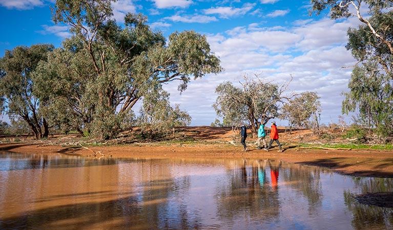 Friends walking along the bank of the billabong at Mount Wood campground. Photo: John Spencer/DPIE