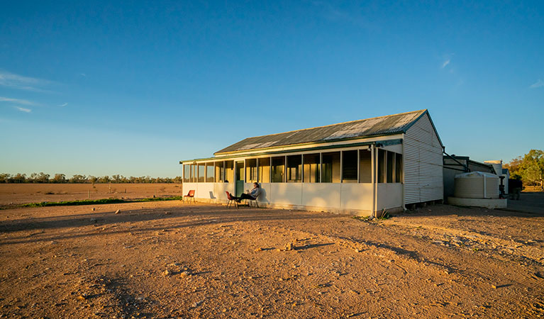 Man reading a book outside Mount Wood Shearers Quarters. Photo: John Spencer/DPIE