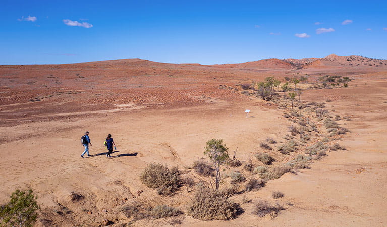 Walkers at the start of Mount Wood Summit walking track in Sturt National Park. Photo: John Spencer/DPIE