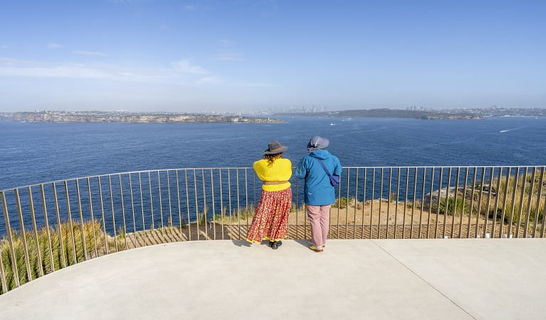 Visitors take in the views across Sydney Harbour and out to South Head from Burragula lookout, Sydney Harbour National Park.  Photo: John Spencer &copy; DPE