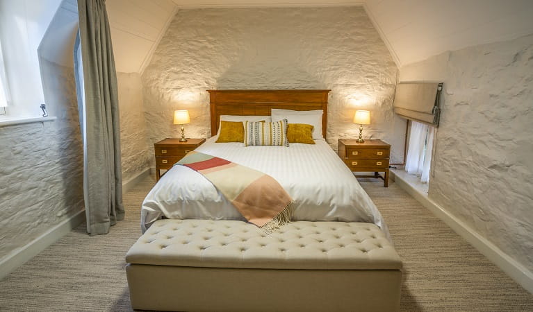 A bedroom with a queen bed in Gardeners Cottage, Sydney Harbour National Park. Photo: John Spencer/DPIE