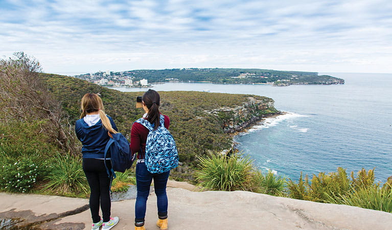 2 friends enjoying the view of Manly and Q Station at Dobroyd Head along Manly scenic walkway in Sydney Harbour National Park. Photo: Simone Cottrell/DPIE