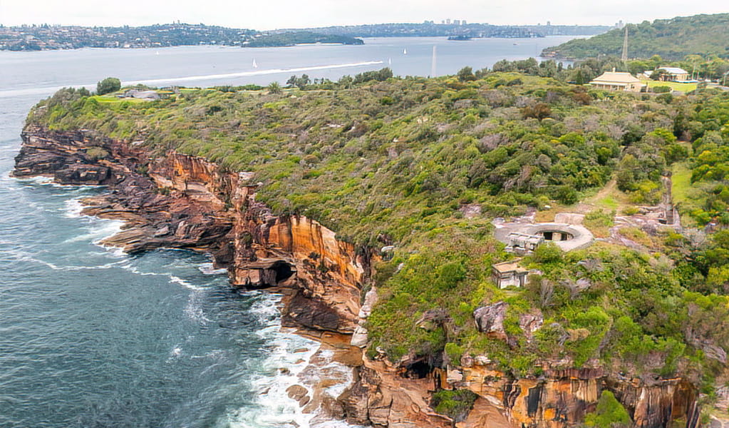 Aerial view of Middle Head, Sydney Harbour National Park, with its orange cliff edge and sea. Photo: Andrew Elliot, &copy; DCCEEW