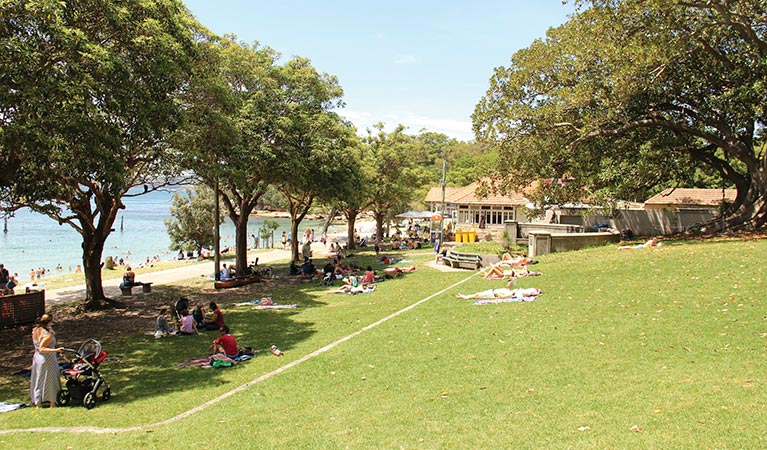 People relaxing on the grassy area in Nielsen Park. Photo: John Yurasek/DPIE