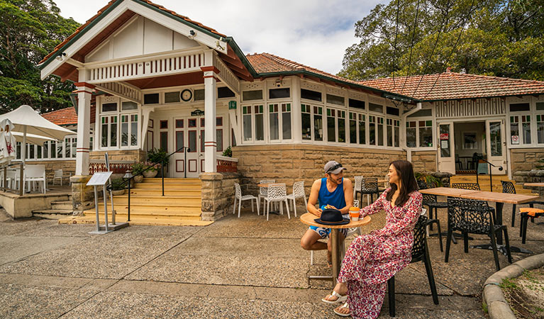 Couple sitting outside The Nielsen cafe in Nielsen Park. Photo: John Spencer/DPIE