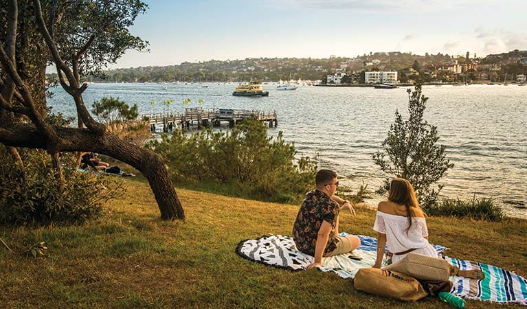 A couple enjoy a picnic on Shark Island – Boowambillee, Sydney Harbour National Park. Photo: John Spencer/OEH