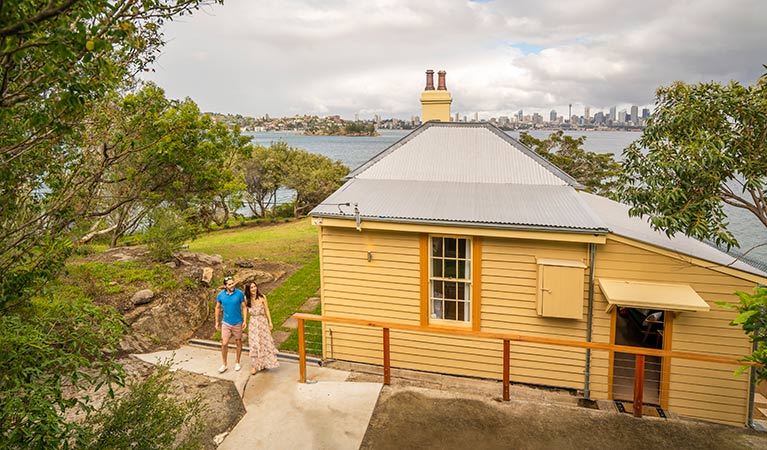 View of Steele Point Cottage from the embarkment with the Sydney Harbour skyline in the distance. Photo: John Spencer/OEH