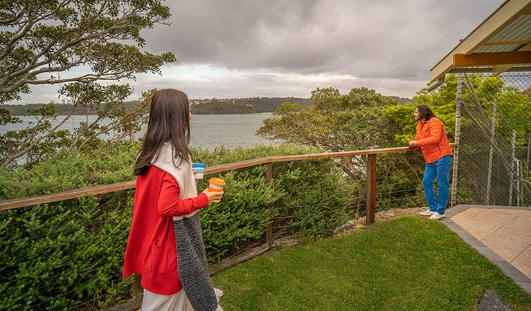 Guests enjoying views of the Sydney Harbour foreshore from the secluded Steele Point Cottage. Photo: John Spencer/OEH