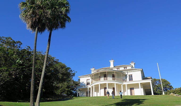 People walking up the grand lawn to Carrara House on Strickland Estate in Sydney Harbour National Park. Photo: E Sheargold/OEH