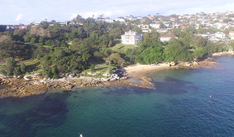 Aerial view showing the harbour foreshore, Milk Beach and Strickland House, Sydney Harbour National Park. Photo: Tommy Ramsay