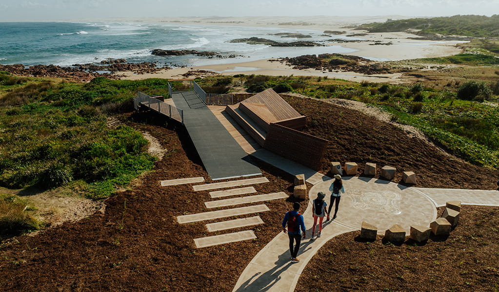 Aerial photo showing people on the boardwalk at Birubi Point Aboriginal Place and the cultural artwork by Worimi man, Gerard Black. Credit: Daniel Parsons &copy; Daniel Parsons