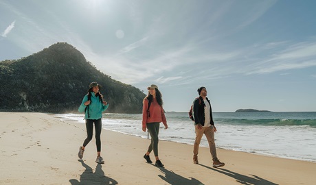 Walkers leaving Zenith Beach with Tomaree Head Summit in the background. Credit: Remy Brand &copy; Remy Brand