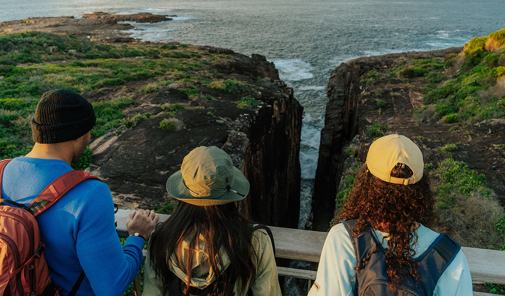 Walkers admire the view from Slot canyon lookout on Tomeree Coastal Walk. Credit: Remy Brand &copy; Remy Brand