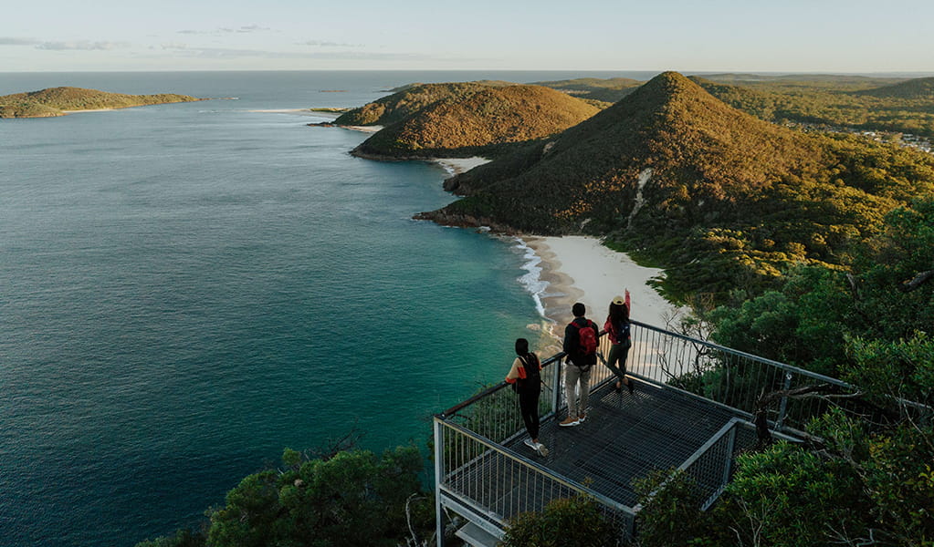 Walkers admire coastal views and islands from the lookout at Tomeree Head Summit. Credit: Remy Brand © Remy Brand