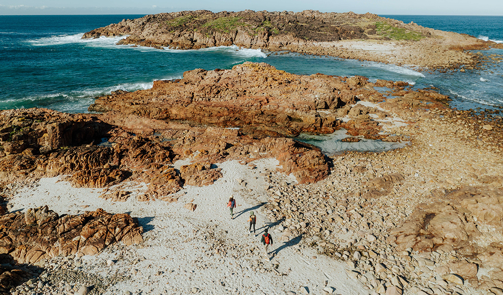 Aerial photo of walkers approaching the coastal rock formations and rockpools at a spot named Big Rocky. Credit: Daniel Parsons © Daniel Parsons