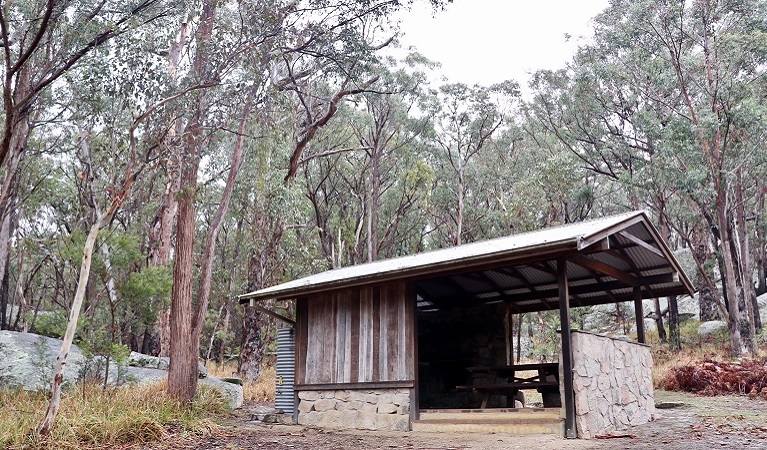 Wood and stone picnic shelter set in woodland in Torrington State Conservation Area. Photo: Shari May/DPIE