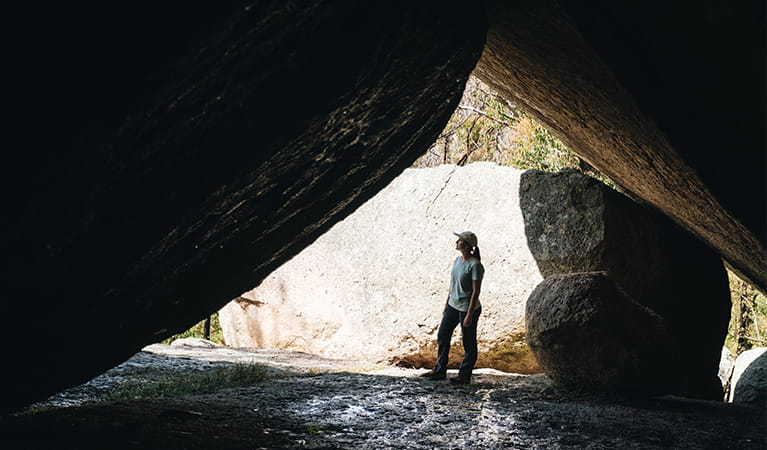 A visitor standing in a cave on the walk to Thunderbolts lookout, Torrington State Conservation Area. Photo credit: Harrison Candlin &copy; Harrison Candlin