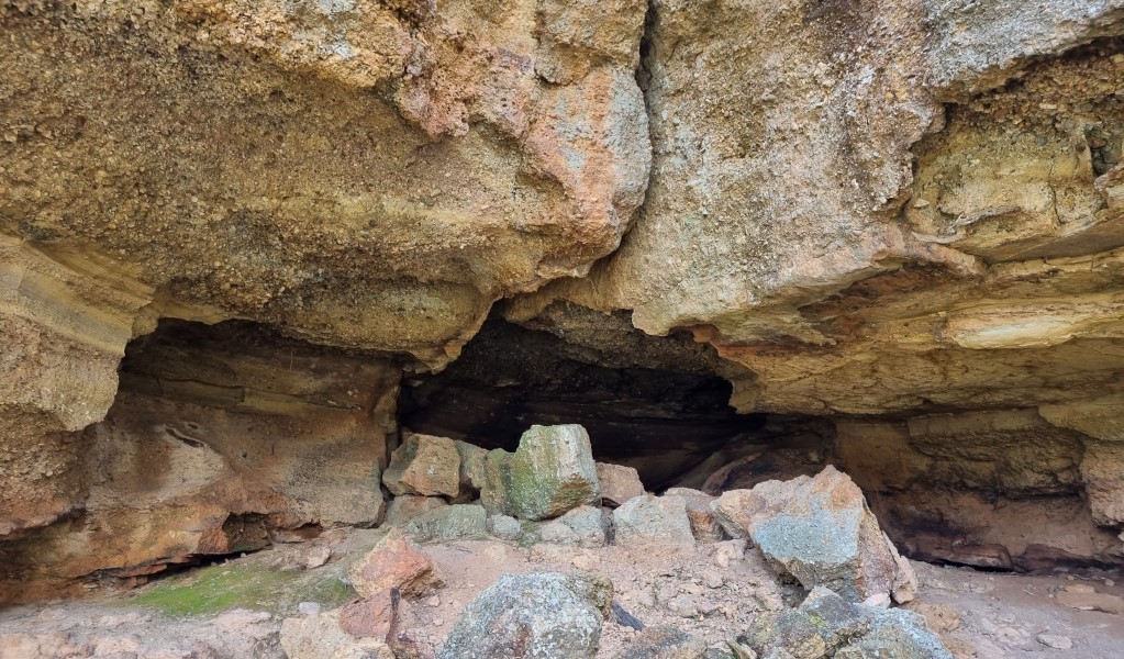 A cave in the sandstone walls along Range View track in Towarri National Park. Photo: Scott Munro &copy; DCCEEW