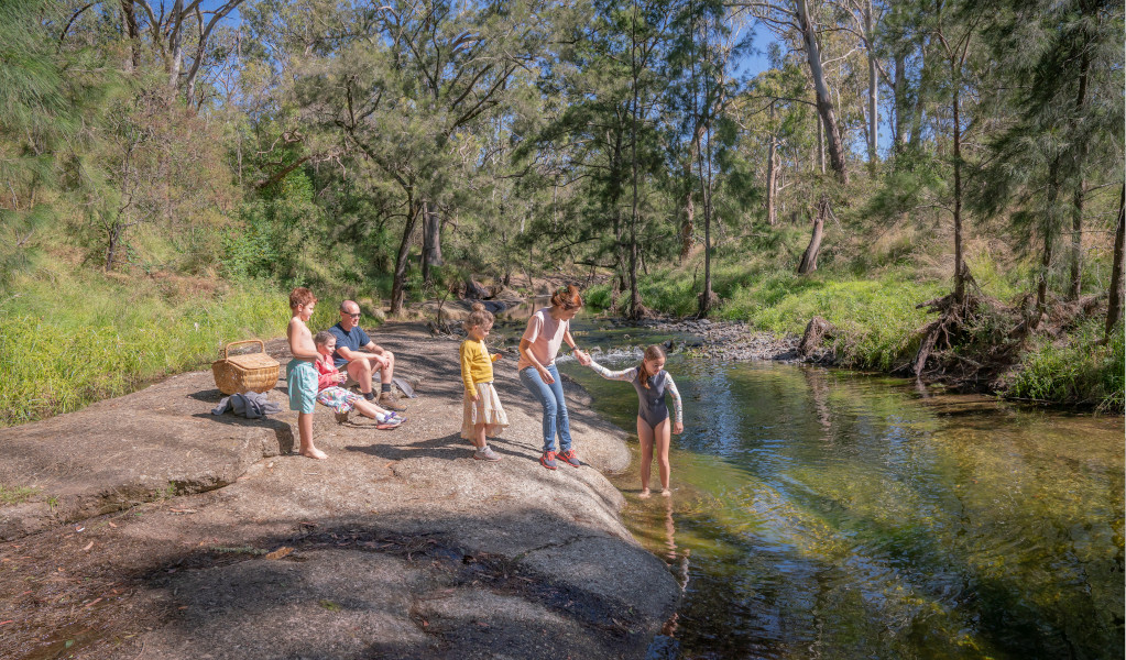 A family enjoying the Washpools waterhole along the Middle Brook.  Credit: John Spencer &copy; DPE 