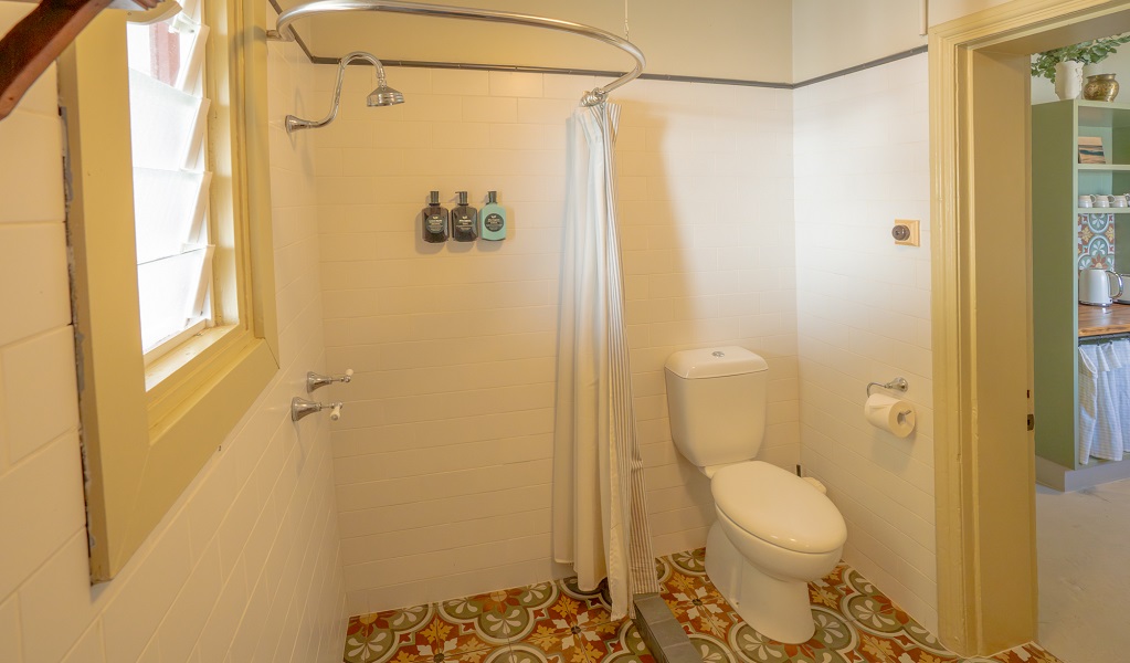 Bathroom, with step-in shower and toilet, Cape Byron Assistant Lighthouse Keepers Cottages. Credit: John Spencer/DCCEEW