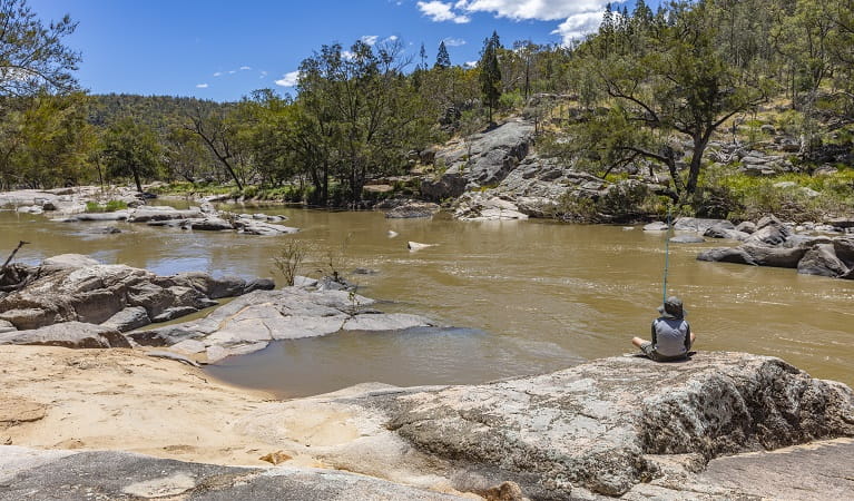 Visitor fishing on the Namoi River with scenic bushland surrounds, Warrabah National Park. Photo: Joshua J Smith &copy; DPE